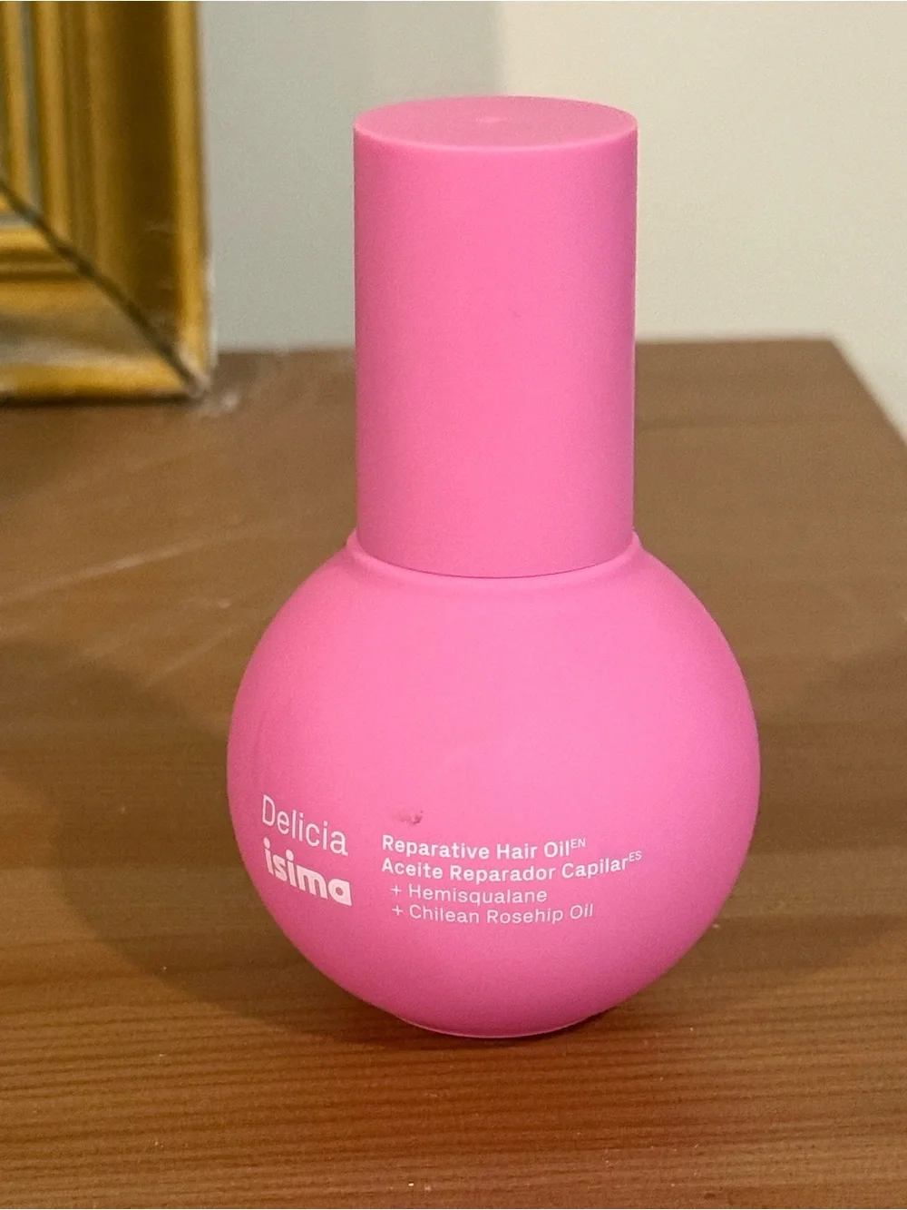 Delicia Isima Reparative Hair Oil - Vibrant Pink Bottle